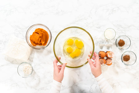 Flat lay. In a cozy kitchen, a large mixing bowl becomes the stage for expertly blending the...