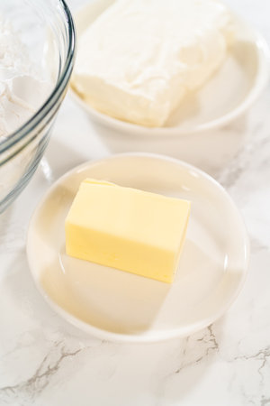 Preparing cream cheese frosting to ice the delicious pumpkin bundt cake.の写真素材