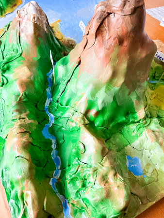 A creative school science project showcasing various landforms, including mountains, valleys,...