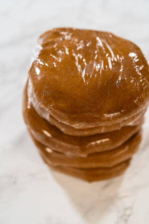 Discs of Classic Gingerbread Cookie Dough are stacked and wrapped in plastic, ready for chilling...