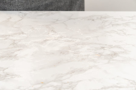 Overhead view of a clean marble countertop after rolling out Amber Gingerbread dough, showing an...