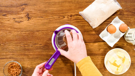 Flat lay. Carefully greasing a bundt cake pan in preparation for baking a delicious bundt cake with...
