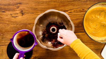 Flat lay. Carefully greasing a bundt cake pan in preparation for baking a delicious gingerbread...