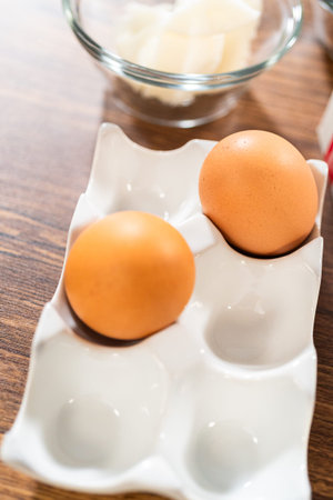 An array of ingredients is meticulously arranged on a wooden table, ready to transform into a...