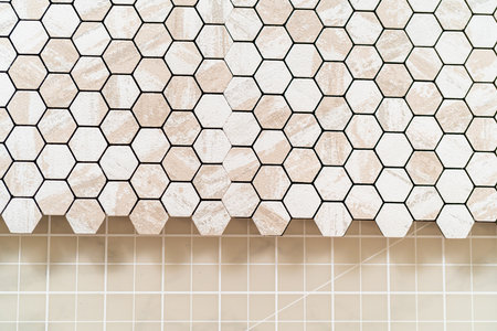 In the process of mounting peel and stick mosaic tiles onto a foam board, perfect for enhancing a food photography studios aesthetic.の写真素材