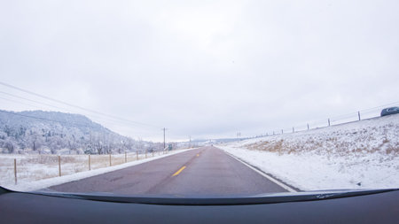 The open highway invites a peaceful drive, with snow-clad pines lining I-25 as the journey continues...