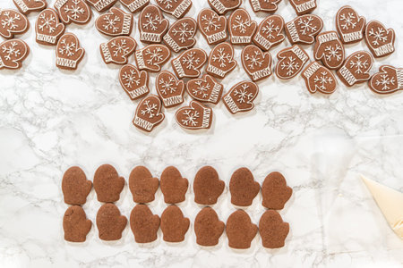 Rows of both decorated and plain mitten cookies are arranged together, highlighting the transition...