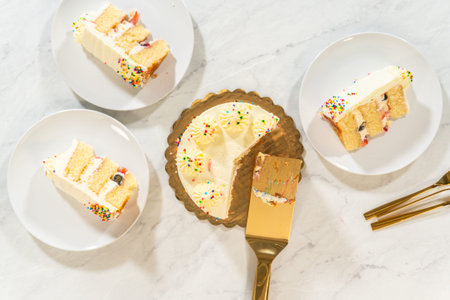 Three plates display slices of frosted cake around the partially eaten cake in its pan. A cake...