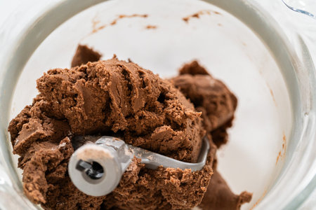 Thick, chocolatey dough formed in the stand mixer for Chocolate Ginger Sugar Cookie Dough, capturing...
