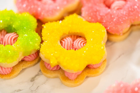 Bright and pastel Easter Cookie Sandwiches decorated with pink Raspberry Buttercream and sugar...