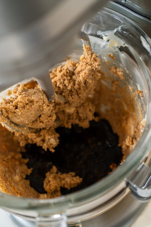 Adding the molasses and egg mixture into the creamed butter and sugar in preparation for Chocolate...