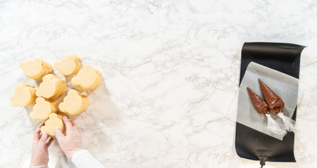 Shortbread Cookies and Piping Bags Description: Top-down view of freshly baked shortbread cookies...