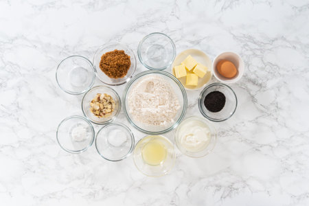 Flat lay. Measured ingredients in glass mixing bowls to bake muffins.