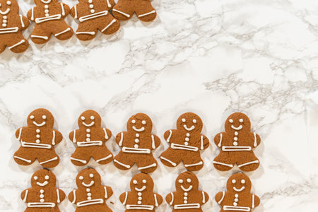 A close-up of fully decorated gingerbread man cookies, emphasizing the detailed icing patterns that make these festive treats stand out.の写真素材