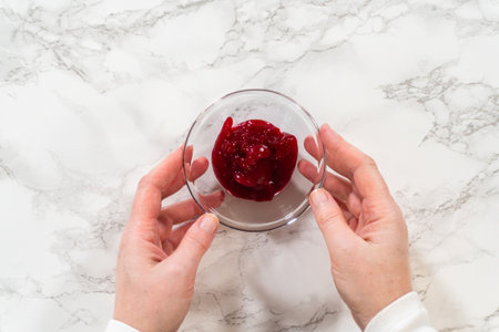 Fresh cranberry sauce ready to be incorporated into the cranberry buttercream for lemon spritz cookies.の写真素材