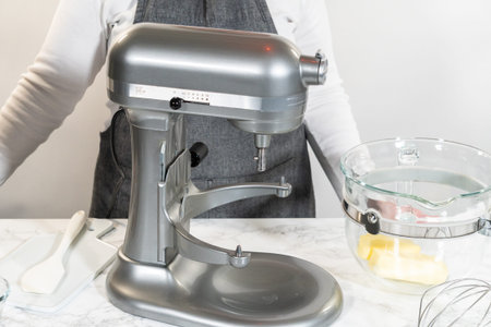 Stand mixer with butter in the bowl and mixing tools nearby, showing prep for making Raspberry...
