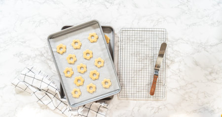 Golden sugar cookies rest on parchment paper after baking. Ideal for recipe posts, baking tutorials,...