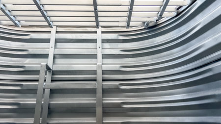 A reinforced galvanized steel window well is shown from the inside, featuring horizontal and vertical support bars. The structure is designed to provide security and light access.の写真素材