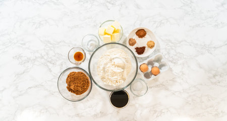 Overhead view of the ingredients arranged for making Classic Gingerbread Cookie Dough, showcasing...
