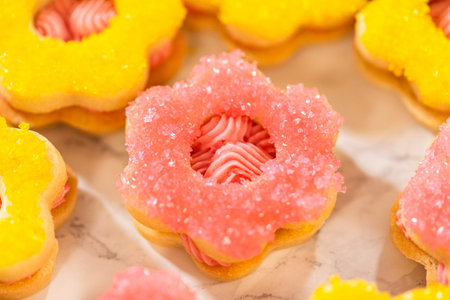 Easter Cookie Sandwiches decorated with bright yellow and green sugar crystals, filled with...