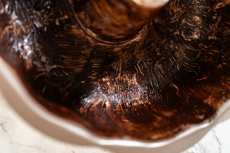 A Bundt pan coated with vegetable shortening and cocoa powder, creating a nonstick surface for the...