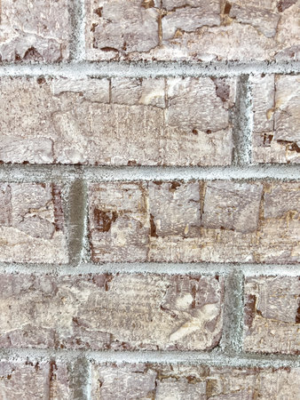 Close-up showing the vertical bricks on a fireplace surface with grout and mortar lines clearly...