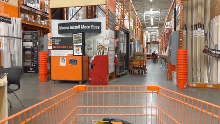 Parker, Colorado, USA-October 26, 2024 - A wide Home Depot aisle featuring signage for windows and services like installation. The area is clean and organized, with orange displays and floor-to-ceiling shelving.