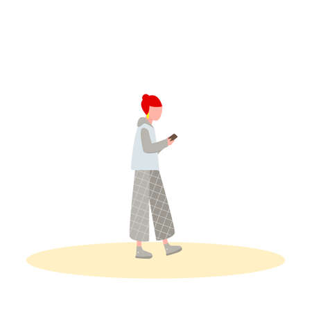 Cute red-haired girl walks in autumn jacket and plaid trousers and looks at the smartphone. Vector illustration.のイラスト素材