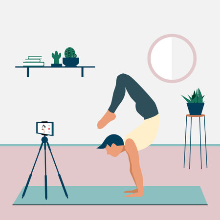 A man records a yoga video tutorial on his smartphone. A young man standing in the scorpion handstand pose Vrschikasana. Stay home concept. Home activity during quarantine. Online courses, educationのイラスト素材