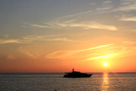 yacht sailing on the black sea with a beautiful sunsetの写真素材