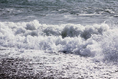 wave splash on the black seaの写真素材