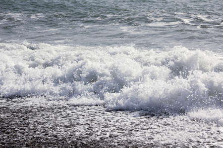 wave splash on the black seaの写真素材