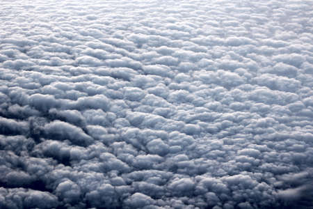 view of fluffy clouds from the plane windowの写真素材