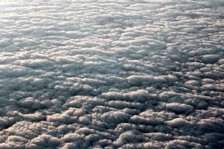 view of fluffy clouds from the plane windowの写真素材