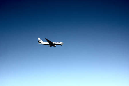 the plane UTair is flying in the blue skyのeditorial素材