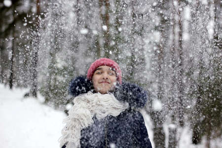 girl playing with snow in the forestの写真素材