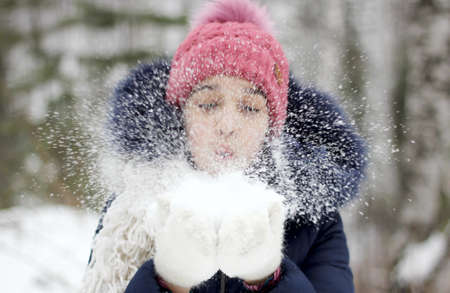 girl playing with snow in the forestの写真素材