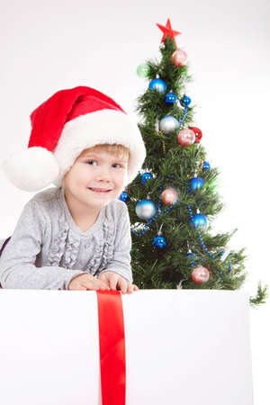 little girl near the Christmas Tree, in studioの写真素材