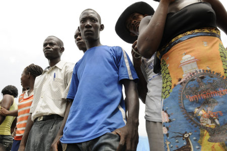 PORT-AU-PRINCE - SEPTEMBER 1: Camp residents standing on the street to witness a rally, in...