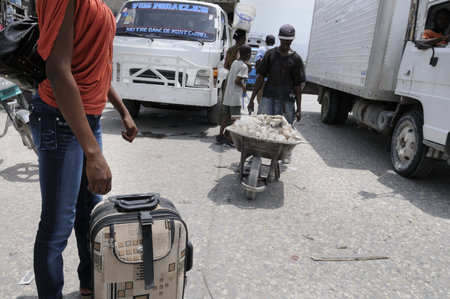 PORT-AU-PRINCE - AUGUST 21: An woman waiting for a Tap-Tap , a form of public transport on the busy...