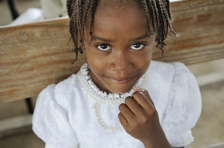 PORT-AU-PRINCE - AUGUST 22: An unidentified Haitian kid smiling after finishing her food during a food distribution camp in Port-Au-Prince, Haiti on August 22, 2010.のeditorial素材