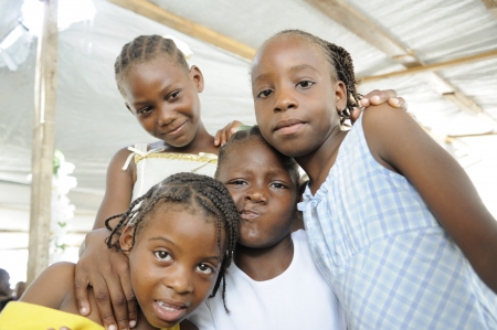PORT-AU-PRINCE - AUGUST 22: A group of Haitian kids having fun amongst themselves during a food distribution camp,in Port-Au-Prince, Haiti on August 22, 2010.のeditorial素材