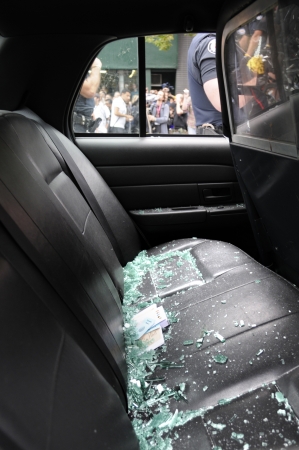 TORONTO-JUNE 26: Broken glasses lie of the back seat of a police car that was vandalized by the protesters during the G20 Protest on June 26 2010 in Toronto, Canada.のeditorial素材