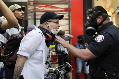 TORONTO-JUNE 26: A protester having an argument with a police officer during the G20 Protest on June...