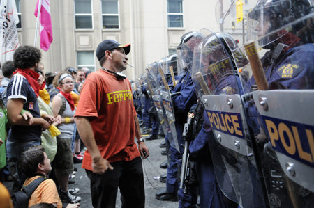 TORONTO-JUNE 26: A protester cranking a joke on the riot police during the G20 Protest on June 26,...