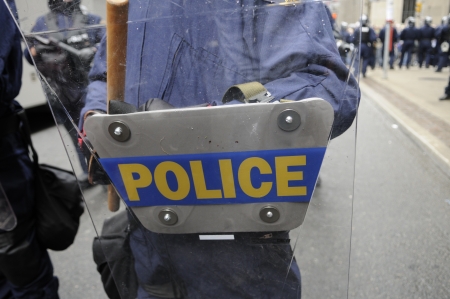 TORONTO-JUNE 26: Police officers blocking protesters with their riot shield during the G20 Protest on June 26, 2010 in Toronto, Canada.のeditorial素材