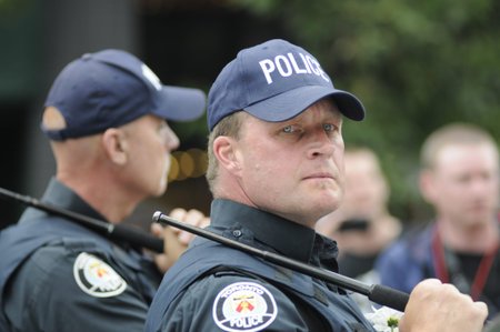 TORONTO-JUNE 26: A visibly angry police officer looking for suspects after one of the police car was...