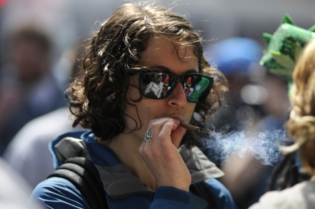 TORONTO - APRIL 20: A marijuana smoking during the annual marijuana 420 event at Yonge & Dundas Square on April 20 2012 in Toronto, Canada.のeditorial素材