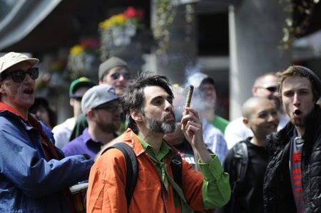 TORONTO - APRIL 20: Marijuana smokers smoking in open during the annual marijuana 420 event at Yonge & Dundas Square on April 20 2012 in Toronto, Canada.のeditorial素材