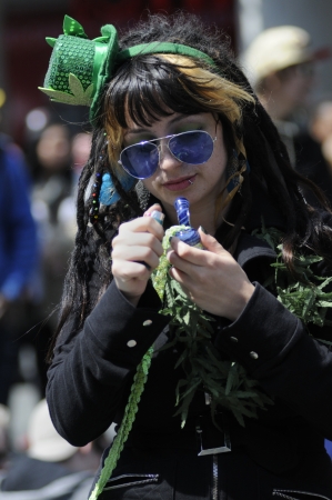TORONTO - APRIL 20: A teenage girl trying to light her Marijuana pipe during the annual marijuana 420 event at Yonge & Dundas Square on April 20 2012 in Toronto, Canada.のeditorial素材